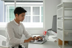 A prospective candidate reading a digital marketing job description on his computer.