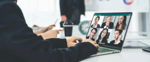 An employee uses horizontal SaaS app Zoom to video call with colleagues in different locations.