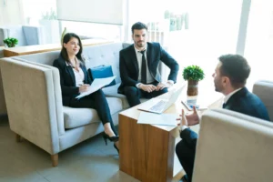 Three members of a data governance committee meeting to discuss data governance roles and responsibilities.